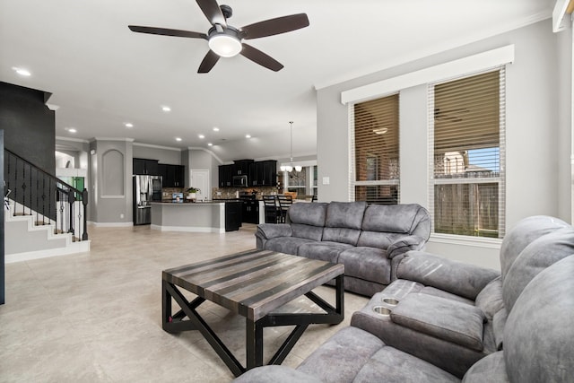 living room with ceiling fan and crown molding