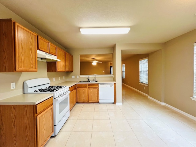 kitchen with light tile patterned flooring, sink, white appliances, ceiling fan, and a textured ceiling