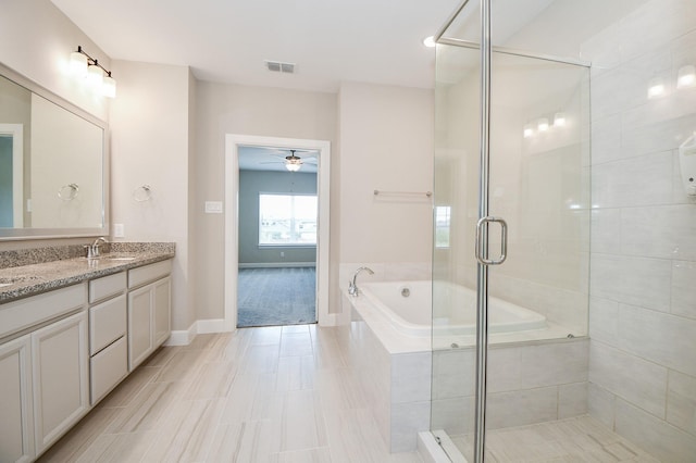 bathroom featuring ceiling fan, vanity, and independent shower and bath