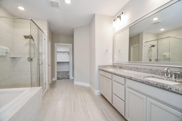 bathroom featuring vanity and an enclosed shower