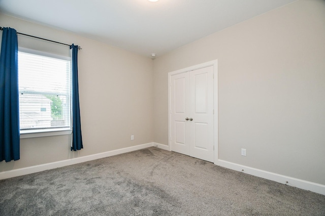 unfurnished room featuring carpet and plenty of natural light