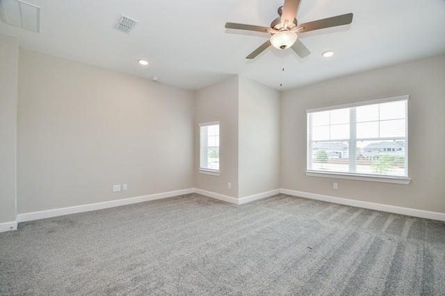 carpeted empty room featuring ceiling fan and a healthy amount of sunlight