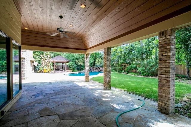 view of patio featuring a gazebo, ceiling fan, and a fenced in pool