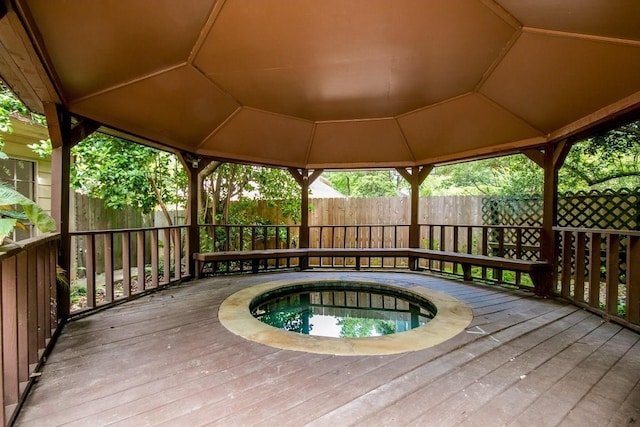 wooden deck featuring an in ground hot tub