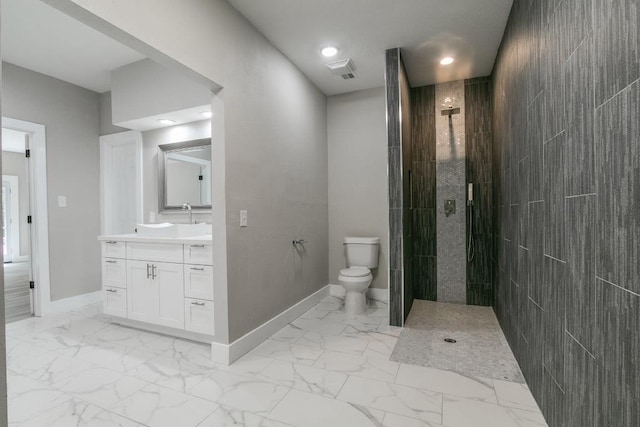 bathroom featuring a shower, vanity, and toilet