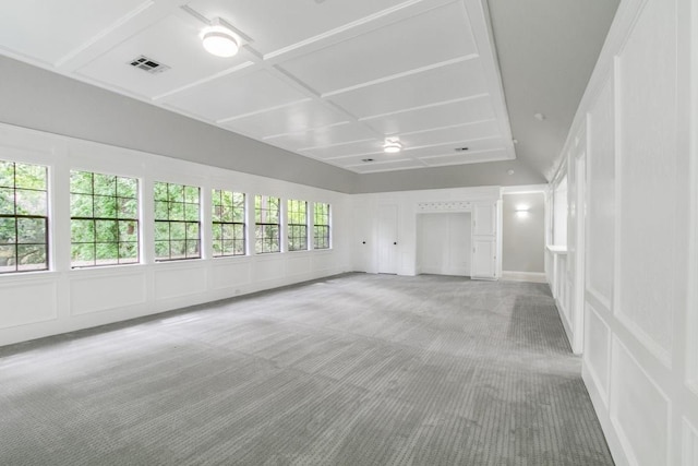 unfurnished living room featuring carpet flooring and coffered ceiling