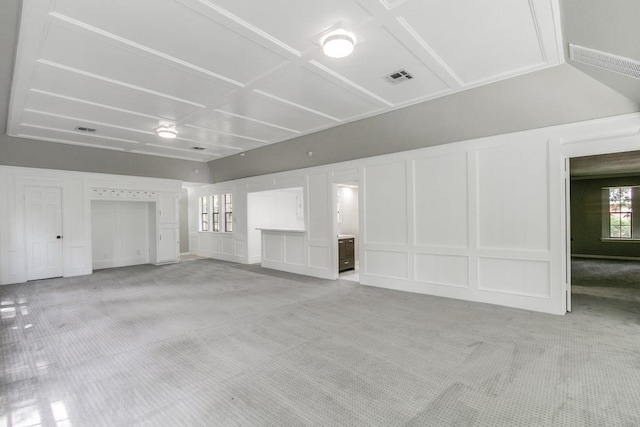 unfurnished living room featuring light carpet