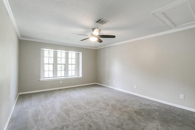 carpeted spare room with ceiling fan and ornamental molding