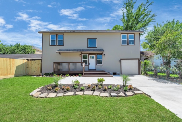 view of property featuring a front yard and a garage