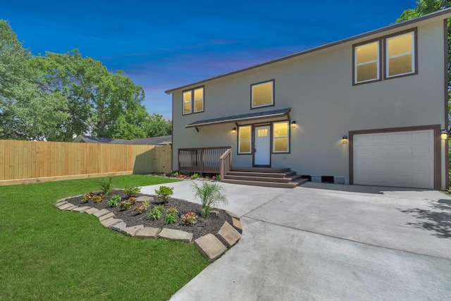 view of front of house with a garage and a lawn