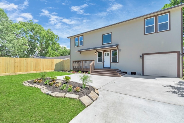 view of front of property featuring a garage, a deck, and a front yard