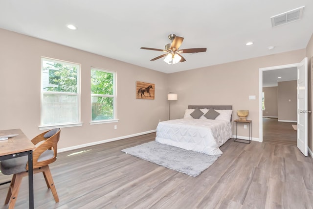 bedroom with ceiling fan and light hardwood / wood-style flooring