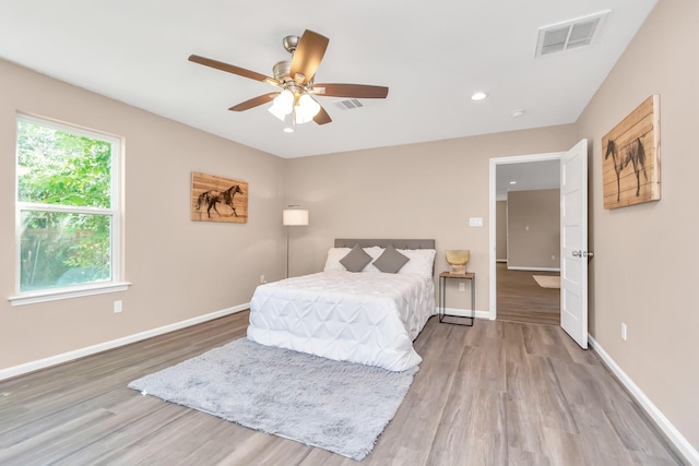 bedroom with ceiling fan and hardwood / wood-style floors