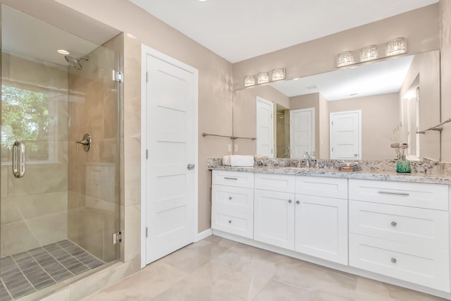 bathroom featuring vanity and an enclosed shower