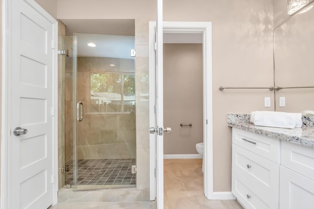 bathroom featuring vanity, toilet, and walk in shower