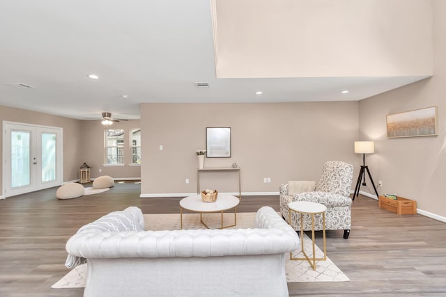 living room with hardwood / wood-style floors, french doors, and ceiling fan