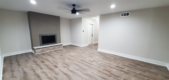 unfurnished living room featuring light wood-type flooring and ceiling fan