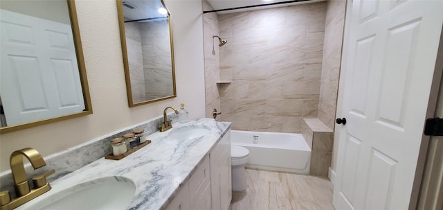 full bathroom with vanity, toilet, and tiled shower / bath