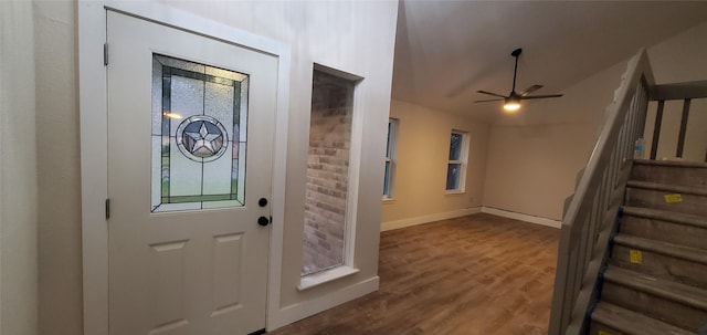 doorway featuring hardwood / wood-style floors and ceiling fan