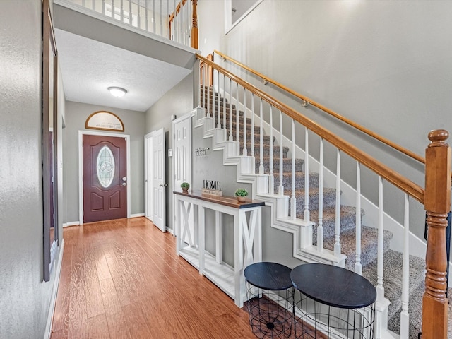 entrance foyer featuring hardwood / wood-style floors and a textured ceiling