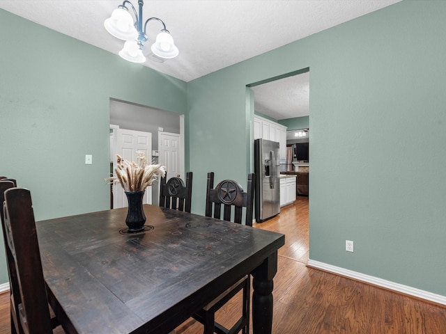 dining room featuring an inviting chandelier and light hardwood / wood-style flooring