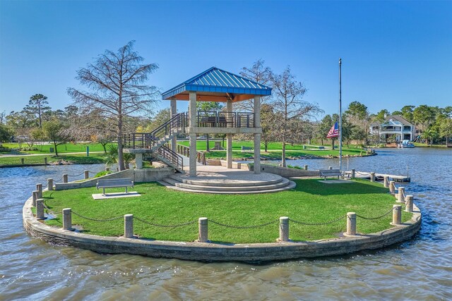 view of jungle gym featuring a gazebo, a water view, and a lawn