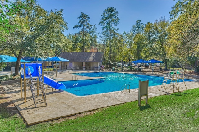 view of swimming pool featuring a patio and a water slide