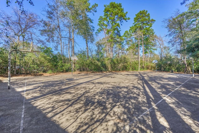 view of yard with basketball hoop