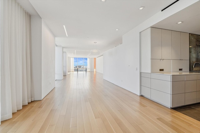 interior space featuring light hardwood / wood-style flooring and a notable chandelier