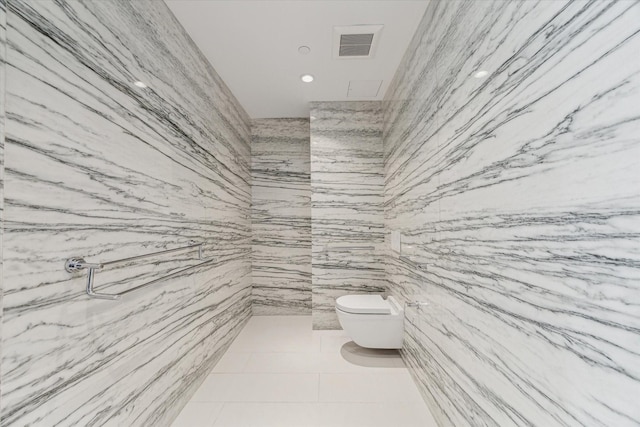 bathroom featuring toilet and tile patterned flooring