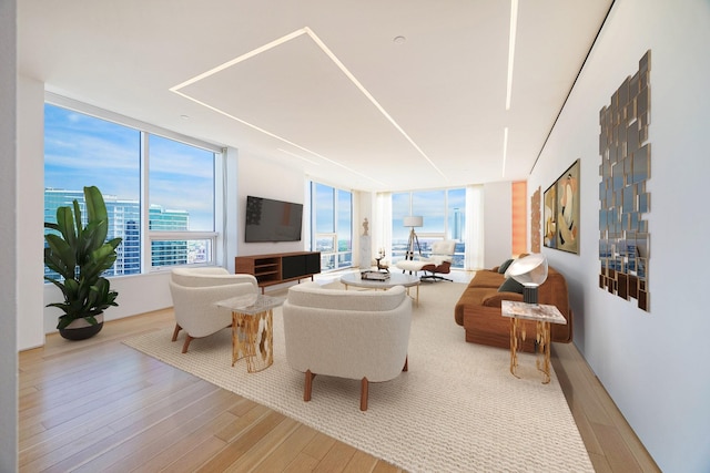 living room with a water view and light hardwood / wood-style floors