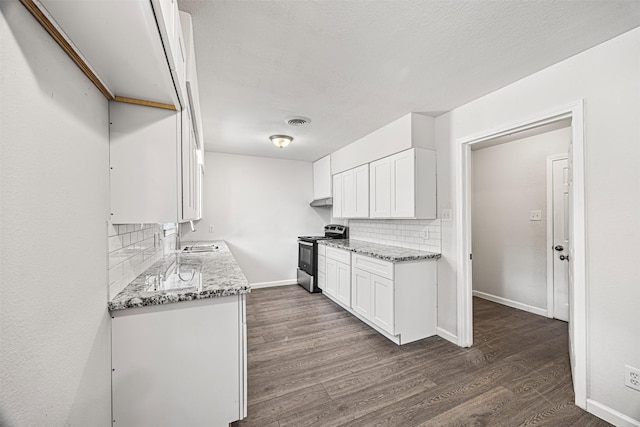 kitchen with white cabinets, decorative backsplash, stainless steel range oven, and light stone counters