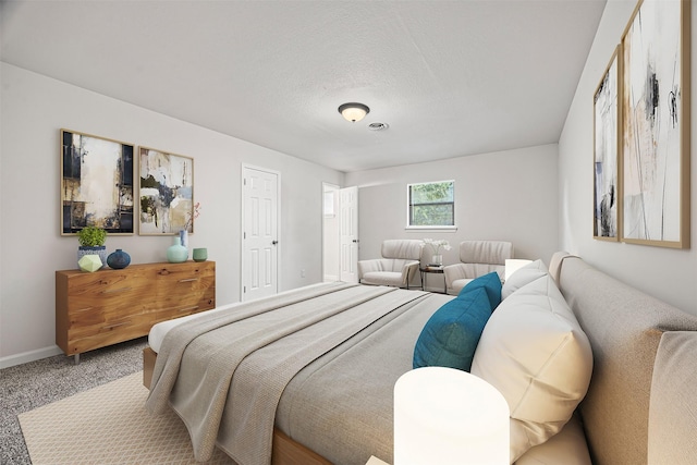 bedroom featuring carpet flooring and a textured ceiling