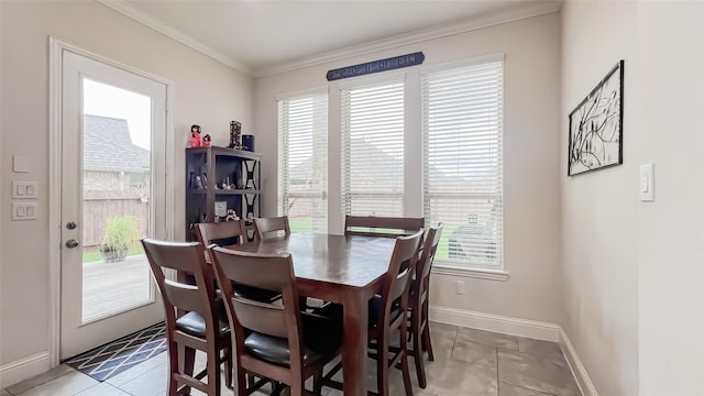 dining space featuring plenty of natural light, light tile patterned floors, and ornamental molding