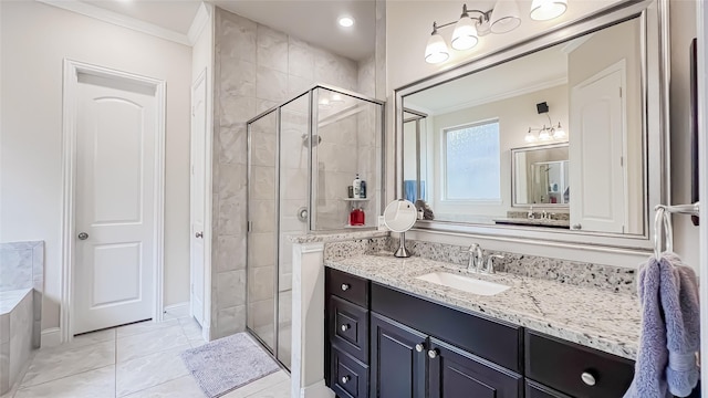 bathroom with vanity, a shower with shower door, and ornamental molding