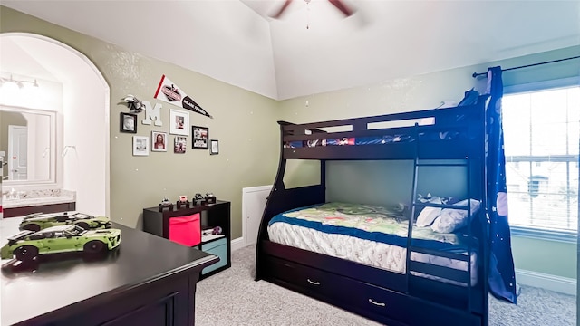 carpeted bedroom featuring multiple windows, ceiling fan, and lofted ceiling