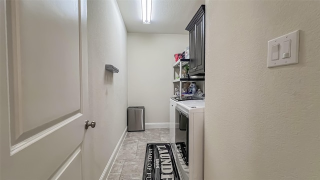 washroom with cabinets and washing machine and dryer