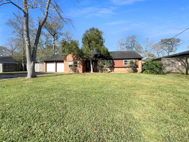 single story home featuring a front yard and a garage