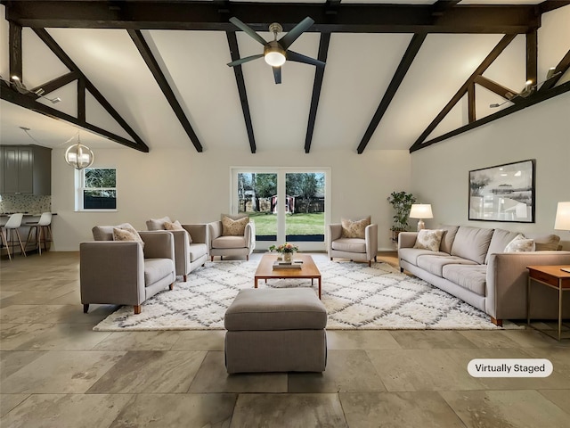 living room with beam ceiling, high vaulted ceiling, and ceiling fan with notable chandelier