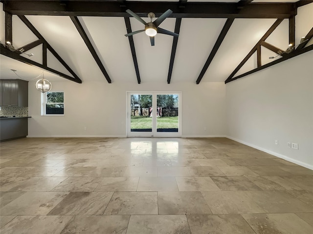 unfurnished living room featuring ceiling fan with notable chandelier and lofted ceiling with beams