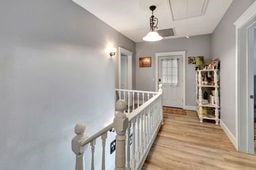 corridor with light hardwood / wood-style floors