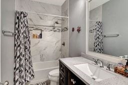 full bathroom with vanity, shower / bath combination with curtain, and toilet