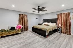 bedroom with ceiling fan and light hardwood / wood-style floors