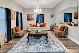 living room featuring a chandelier and hardwood / wood-style flooring