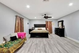 bedroom featuring ceiling fan and light hardwood / wood-style floors