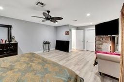 bedroom featuring hardwood / wood-style flooring and ceiling fan