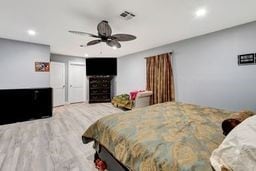 bedroom with ceiling fan and wood-type flooring