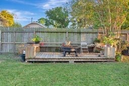 wooden terrace featuring a yard