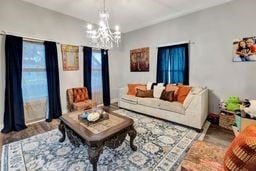 living room with a chandelier and hardwood / wood-style flooring