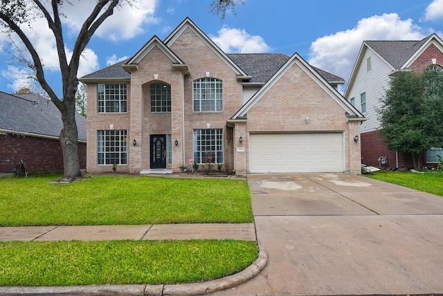 view of front of property with a front yard and a garage